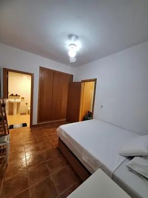 a bedroom with a large bed and a bathroom at Townhouse with pool next to the City of Arts in Valencia
