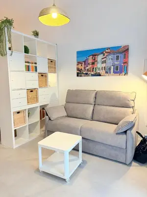 a living room with a couch and a table at Travel Habitat Oceanografic Suites in Valencia