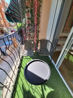 a balcony with chairs and a table and a window at Piso Burjassot - Valencia in Burjasot