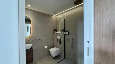 a bathroom with a shower and a toilet and a sink at Boutique Room - Plaza Tower in Valencia