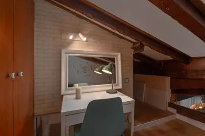 a room with a desk with a television and a chair at La Casa de las CestaS in Valencia