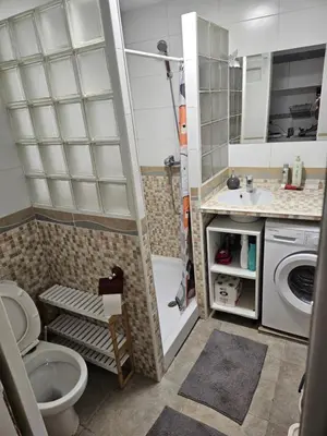 a bathroom with a shower and a toilet and a sink at Cosy house near the castle in Cullera