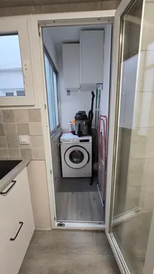 a small kitchen with a washing machine in a tiny house at Apartamento Musical in Cullera