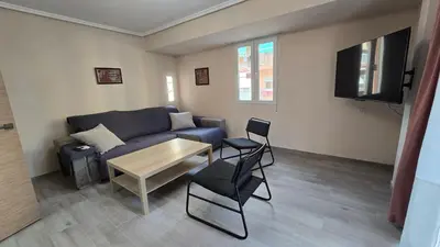 a living room with a couch and a table at Apartamento Musical in Cullera