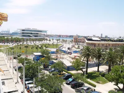 a city with cars parked in a parking lot at El Coso in Valencia