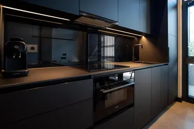 a kitchen with black cabinets and a counter top at Central loft 60 m2 ideal for small families in Valencia