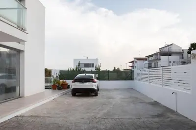 a car parked in a parking lot next to a building at Casa Blanca - Villa con piscina in Chiva