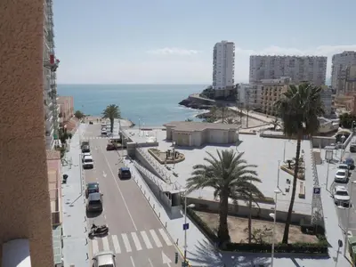 a street in a city with the ocean in the background at Navarrete, 4-20 in Cullera