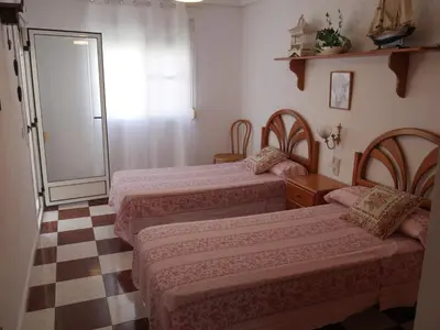 a room with three beds and a checkered floor at Navarrete, 4-20 in Cullera