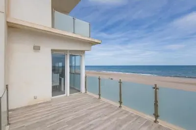 a balcony with a view of the beach at Villa Prestige Beach in Mareny Barraquetas