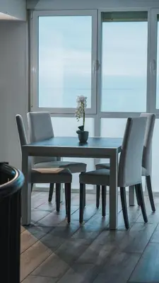 a dining room table and chairs with a vase on it at Villa Prestige Beach in Mareny Barraquetas