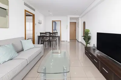 a living room with a couch and a tv at ApartUP Patacona Splendor in Valencia