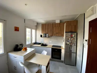 a kitchen with wooden cabinets and a stainless steel refrigerator at Bright & Quiet Apartment Close to Central Valencia in Valencia