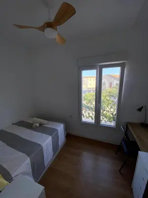a bedroom with a bed and a large window at Bright & Quiet Apartment Close to Central Valencia in Valencia