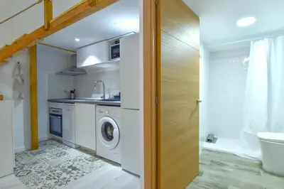a kitchen with a washer and dryer in a bathroom at Alójate en el Puerto de Valencia 1 in Valencia