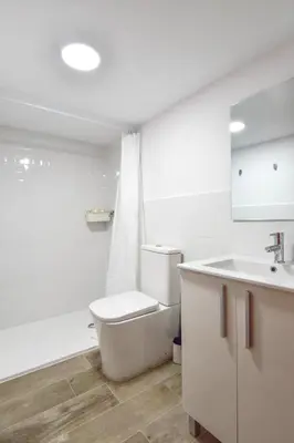 a white bathroom with a toilet and a sink at Alójate en el Puerto de Valencia 1 in Valencia