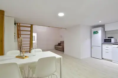 a kitchen and living room with a white table and chairs at Puerto de Valencia 2 in Valencia