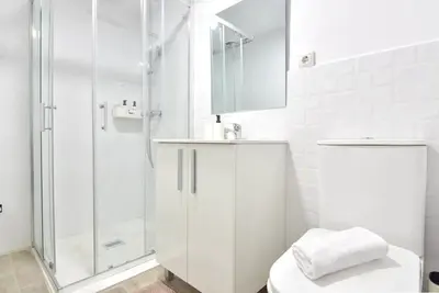 a white bathroom with a shower and a toilet at Puerto de Valencia 2 in Valencia