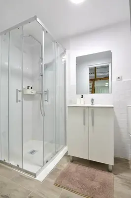 a white bathroom with a shower and a sink at Puerto de Valencia 2 in Valencia