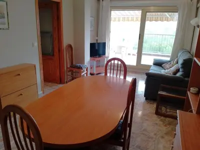 a living room with a wooden table and a couch at Van-Dyck, ESC-4, 6-24 PK 18 in Cullera