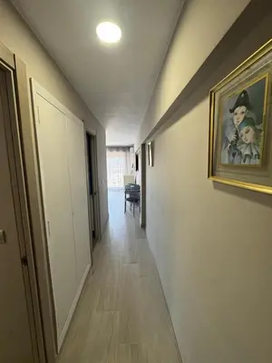 a hallway with a painting of two children on the wall at apartamento con vistas en la playa de San Antonio in Cullera