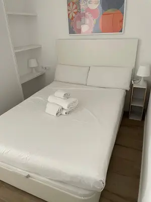 a white bed with towels on top of it at New luxury studio in the city center in Valencia