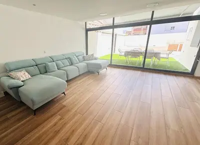 a living room with a couch and a table at Casa con PISCINA y CINE in Paterna