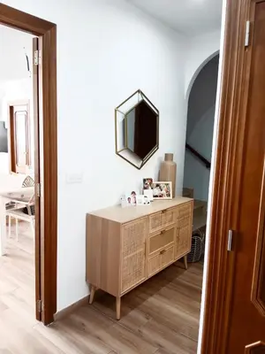 a room with a dresser and a mirror on the wall at Casa con PISCINA y CINE in Paterna