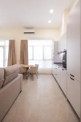 a kitchen and living room with a couch and a table at Benimamet Suite by Concept Flats in Valencia