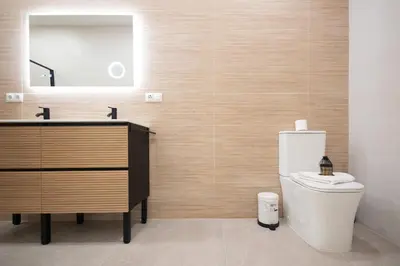 a bathroom with a toilet and a sink and a mirror at Benimamet Suite by Concept Flats in Valencia