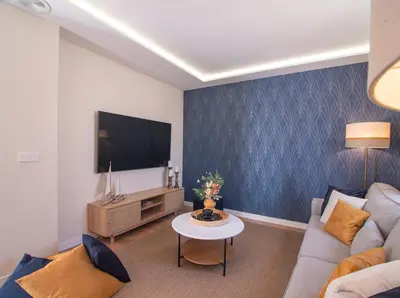 a living room with a couch and a tv at MD Villa Barraques de Lluna in Valencia
