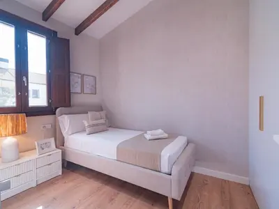 a small bedroom with a bed and a window at MD Villa Barraques de Lluna in Valencia