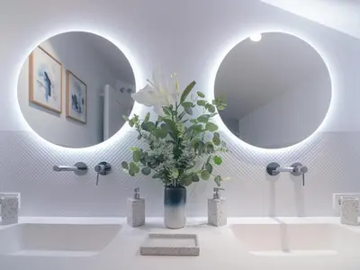 a bathroom with a mirror and a vase with white flowers at MD Villa Barraques de Lluna in Valencia