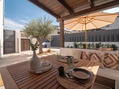 a wooden table with a vase on a patio at MD Villa Barraques de Lluna in Valencia