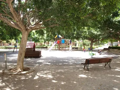 a park with a playground with a bench and a tree at L'Umbracle Views in Valencia