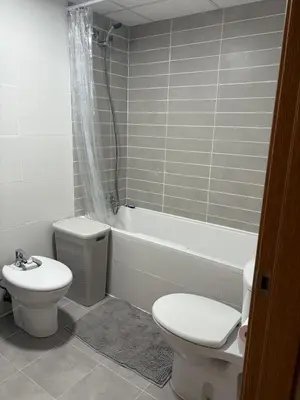 a bathroom with a toilet and a tub and a sink at Seira Apartment in Burriana