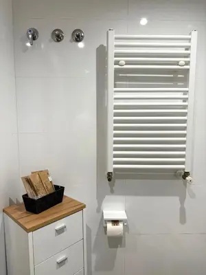 a white bathroom with a toilet and a window at Apartamento turístico Playa Valencia in Valencia