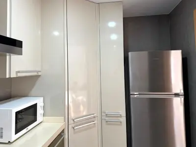 a kitchen with a refrigerator and a microwave at Apartamento turístico Playa Valencia in Valencia