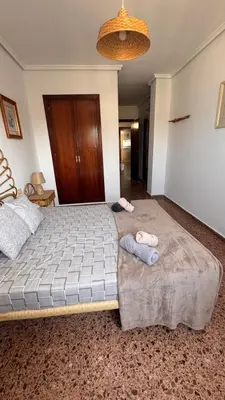 a bedroom with two beds with towels on them at Apartamento entero Playa Perello Valencia in El Perelló