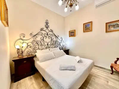 a bedroom with a white bed with a metal headboard at Urban Style in Valencia