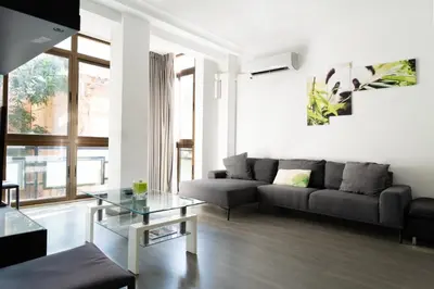 a living room with a couch and a table at GuestReady - Spacious City Haven in Valencia in Valencia
