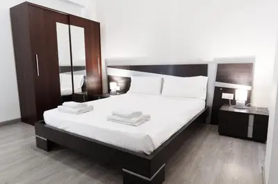 a bedroom with a large bed with two towels on it at GuestReady - Spacious City Haven in Valencia in Valencia