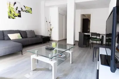 a living room with a glass table and a couch at GuestReady - Spacious City Haven in Valencia in Valencia