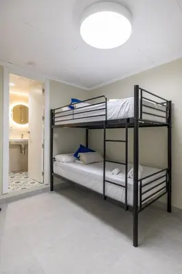 two bunk beds in a room with a mirror at Carmen Beach Hostel Cullera in Cullera