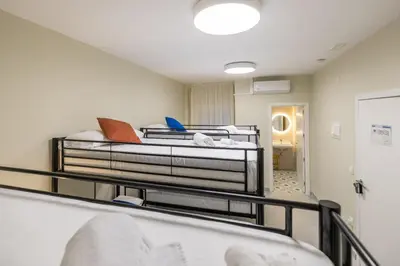 a room with two beds in a room at Carmen Beach Hostel Cullera in Cullera