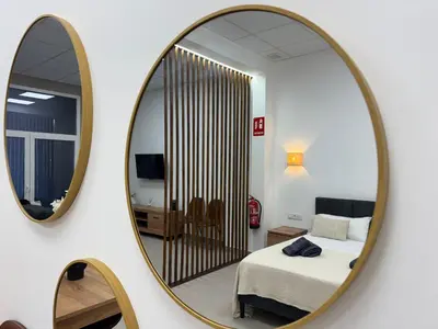 a bedroom with a bed and a mirror at Basset 3 in Valencia