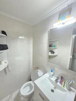 a white bathroom with a toilet and a sink at All you need in Valencia