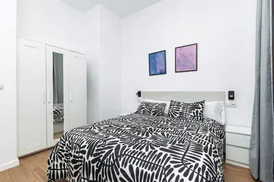 a white bedroom with a black and white bed at Quiet & Modern Apartment in Valencia