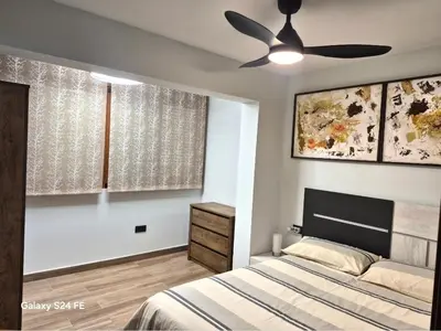 a kitchen with a table and chairs and a refrigerator at Brisa Marina in Cullera