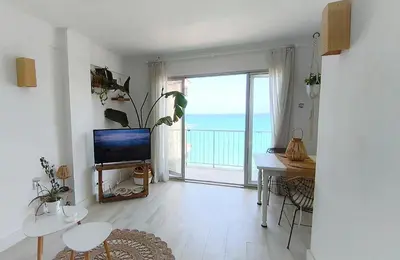 a living room with a television and a view of the ocean at Faro Cullera Sea view in Faro de Cullera